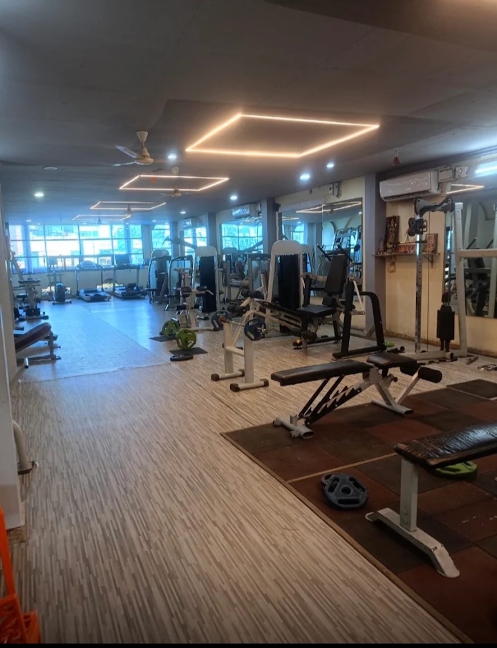 Bhandari Gym workout floor with benches, strength equipment and cardio machines